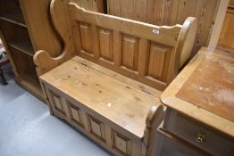 A modern natural pine box settle