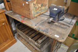 A wooden trestle style workbench/potting bench
