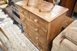A stained pine chest of two over three drawers