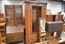 A Victorian mahogany mirror door wardrobe having drawer base