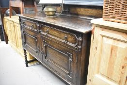 A late 19th/early 20th Century sideboard having ledge back , cushioned type drawers and door fronts