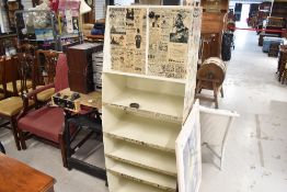A vintage metal cabinet with shelves under, interesting decoupage finish with newspaper adverts