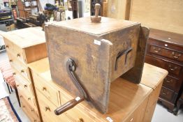 A traditional stained frame table top butter churn