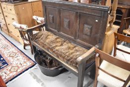 A period oak settle/pew made out of a 19c bed head having panelled back