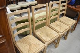 A set of four traditional ladder back rush seated dining chairs