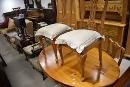 A modern pine oval dining table on splay legs and a set of stained frame dining chairs