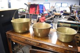 Three graduated brass jam pans