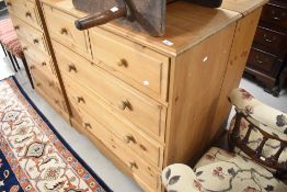 A modern natural pine chest of two over three drawers