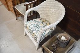 A Lloyd Loom or similar tub chair