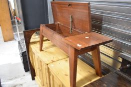 A vintage teak work table with lift top