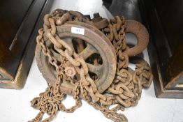 An antique block and tackle or similar chainwork, possibly shipping related