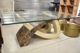 An Itallian designer coffee table having modernist style base with marble laminated base