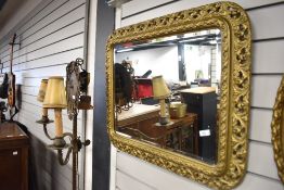 A vintage gilt plaster mirror having foliate frame