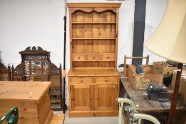 A natural pine dresser of narrow proportions