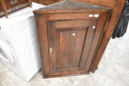 A period oak corner cupboard