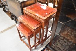 A nest of three hardwood oriental style tables