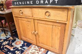 A vintage golden oak sideboard having two drawers and double cupboard under, possibly early Ercol