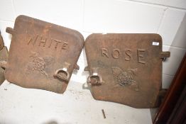 A pair of cast iron boiler doors, from The White Rose Foundry in Yorkshire, with motif to front