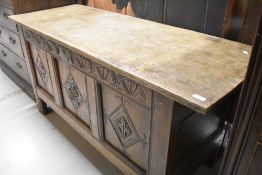 A period oak kist/coffer having three carved panels to front, top possibly later