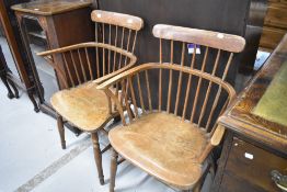 A pair of traditional stained windsor/frame stick back carver chairs having turned H stretcher