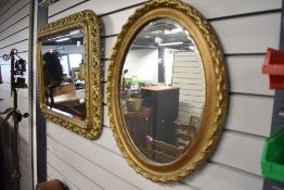 A vintage gilt plaster oval wall mirror