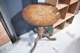 A 19th Century oak pedestal table having circular top, turned column and triple splay legs, nice