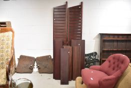 A run of vintage dark stained 'ladderax' shelving units, two widths