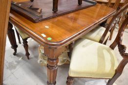A Victorian mahogany dining table , extendable with leaf, on fluted alegs