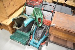 A Bosch electric lawnmower and raker