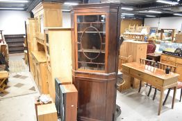 An early 20th Century mahogany corner display with lower cupboard section