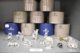 A selection of modern miniature glass figurines by Swarovski crystal including fish, hedgehog,
