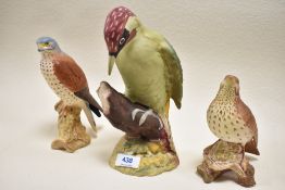 Three bisque Beswick bird figures including Thrush 2308, Kestrel 2316, and Woodpecker 1218