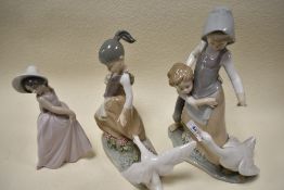 A trio of Lladro Figurines to include boy hugging girl with goose, girl dancing and girl with