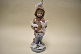 A Lladro figurine,boy with doves, 6129.