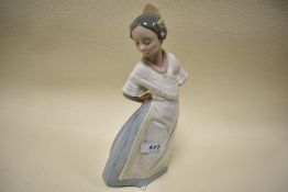 A Nao figurine, young lady in traditional dress.
