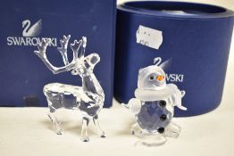 A pair of Swarovski crystal reindeer and a snow man,both with box and certificate.