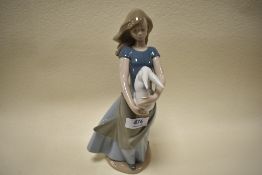 A Nao figurine, young lady holding bunny.
