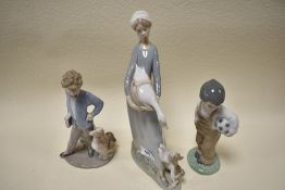 Two Lladro and Nao figurines, to include Sundays child,lady holding goose by puppy and Boy with