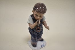 A Dahl Jensen Copenhagen, Denmark figurine,boy with pipe,gloss finish.
