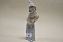 A figurine by Lladro of a girl holding chicken