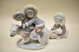 Two Lladro figurines, young Eskimo pair on polar bear, and young child with polar bear cub.