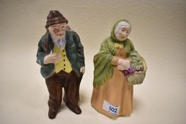 A pair of Coalport figures in bisque glazes of a flower seller and wandering man