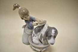 A Lladro figurine,girl bathing dog.