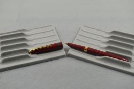 A Conway Stewart Conway 106 fountain pen in red with one broad band to the cap. Approx 13.6cm