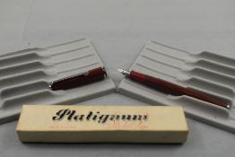 A Platignum Silverline fountain pen in red with single band to cap having Platignum First Quality