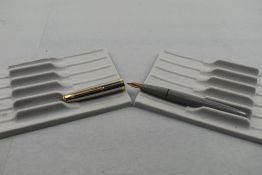 A Conway Stewart Conway 67 fountain pen in grey with steel cap with gold trim having a Conway 14k