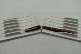 A Parker 17 lady fountain pen in burgundy with narrow band to the cap. Approx 11.7cm