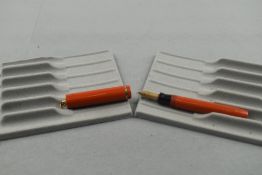A Sheaffer leverfill ring top fountain pen in orange with single band to cap having Sheaffer 46