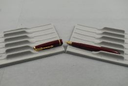 A Parker Slimfold fountain pen in burgundy with narrow decorative band to the cap and having a