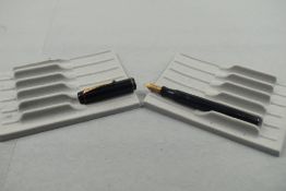 A Mentmore Auto Flow button fill fountain pen in black with single narrow band to the cap having